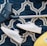 pair of white sneakers beside vacuum cleaner