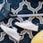 pair of white sneakers beside vacuum cleaner