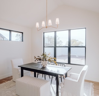 a dining room with a table, chairs, and a bench