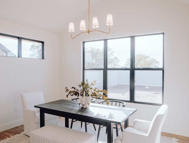 a dining room with a table, chairs, and a bench